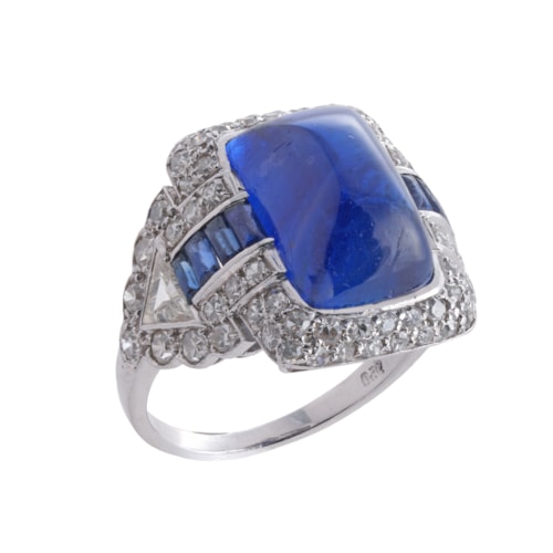 Sugarloaf cabochon sapphire and diamond oblong cluster ring, collet set with a Burma sapphire of rectangular cushion outline,